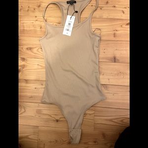 Brand new body suit from dynamite! Only ever tried on once with shorts on!